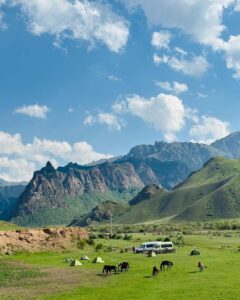 Our remote valley campsite with horses grazing between tents